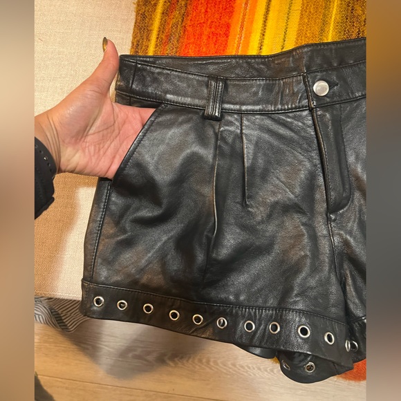 Genuine leather black mini shorts lined with silver metal grommets. Size 8 - Picture 2 of 7
